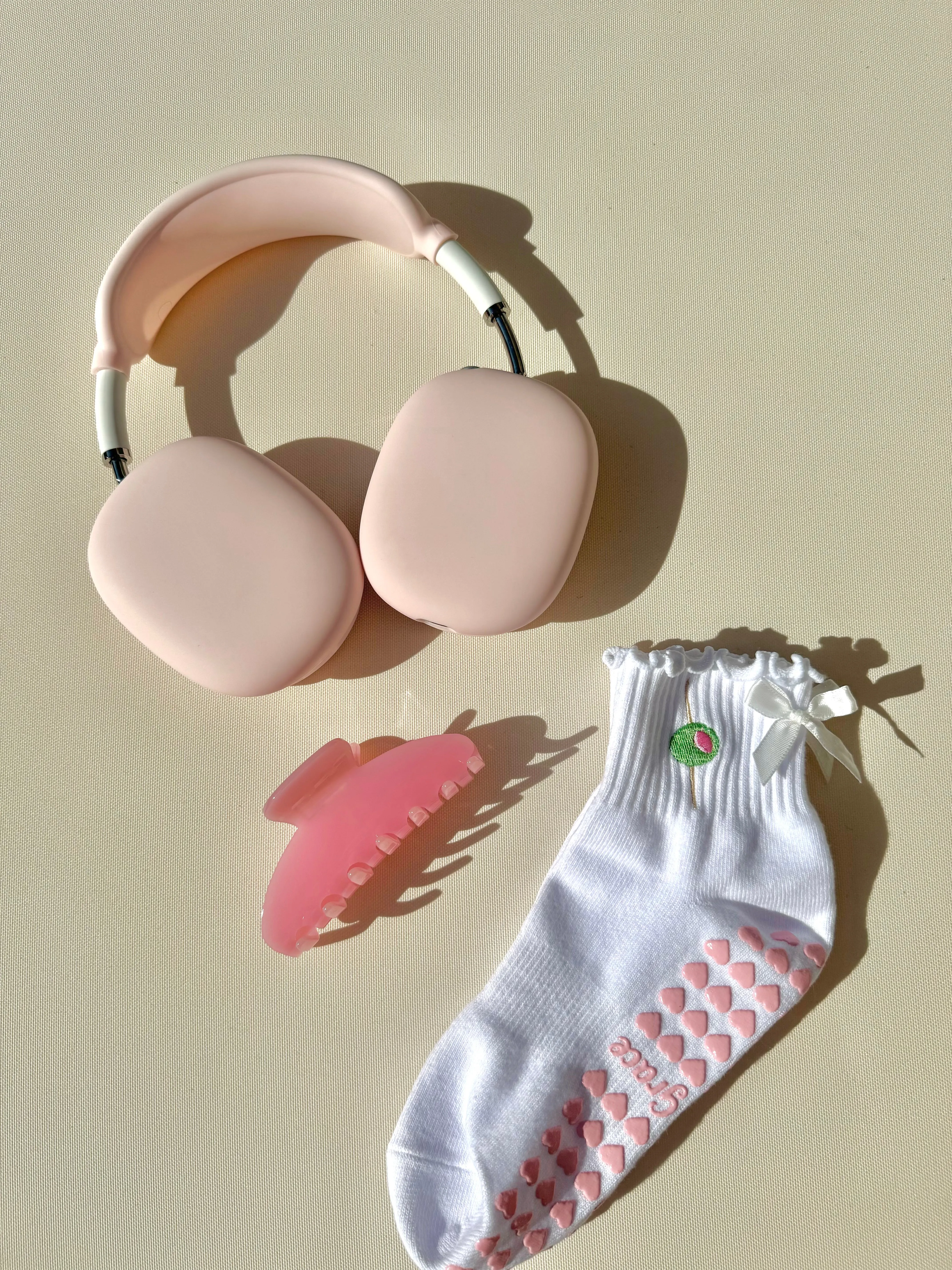 White ruffle olive grip sock with white bow and pink heart grips